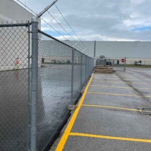 chain link security fence with barbed wire installed for commercial property